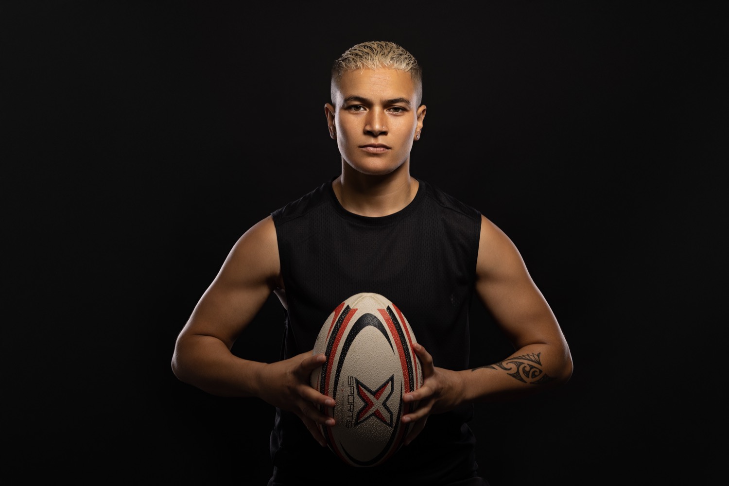 Studio portrait of a New Zealand representative rugby league player holding a ball
