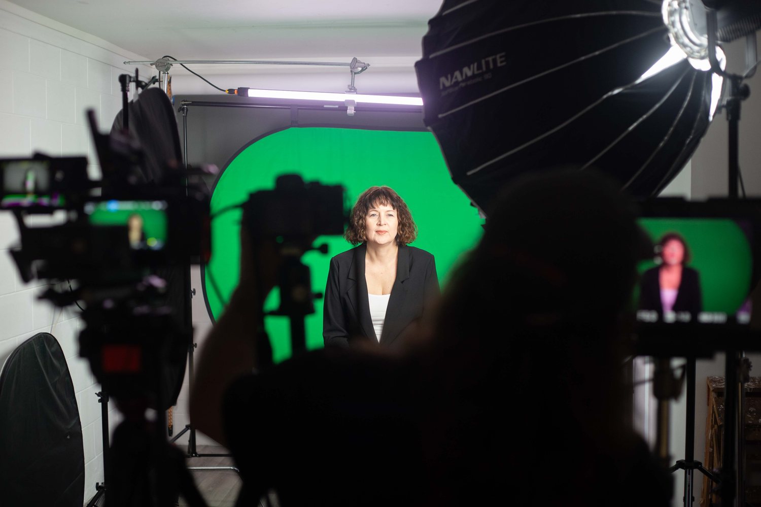 A digital twin filming session with monitors showing the live feed