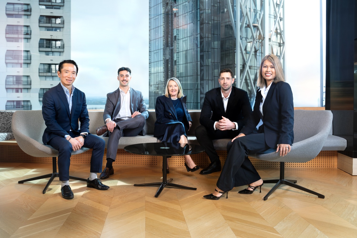 A corporate team photographed together in their Auckland office by Belinda Bullock